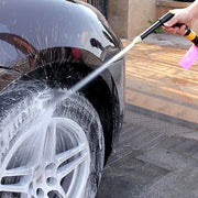 Hand rotating the multi-mode brass spray gun nozzle to select different water patterns.