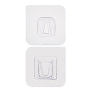 Two white no-drill adhesive hooks mounted on a smooth, clean wall surface.