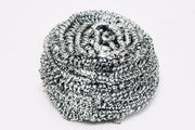 Round stainless steel scrubber showing its intricate wire design for superior scrubbing.
